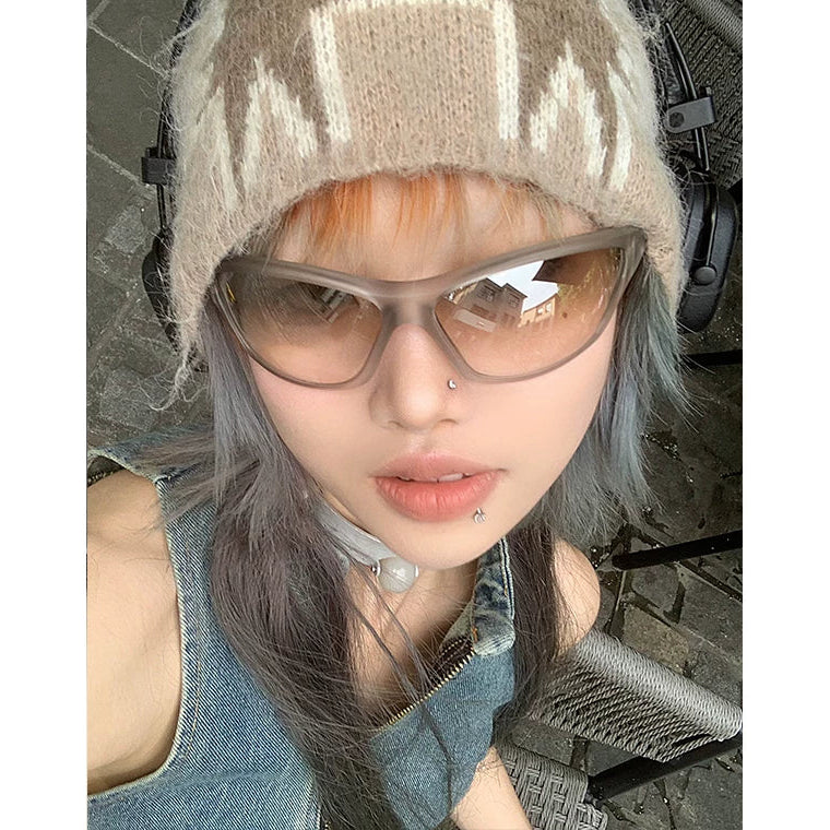 Futuristic Angular Sunglasses — Model wearing silver sunglasses with knit hat