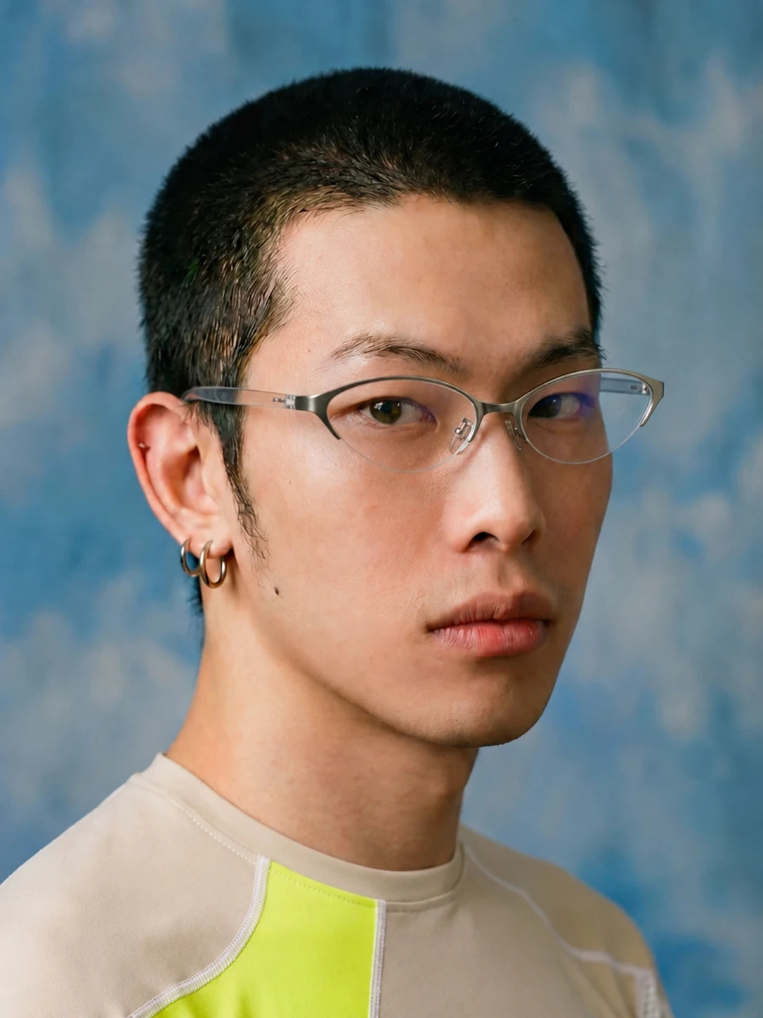 Model wearing silver-tone metal cat-eye glasses, side view