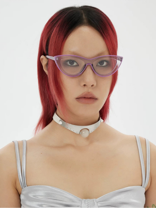 Retro Triangular Cat-Eye Glasses — Model wearing pale triangular cat-eye clear-lens glasses