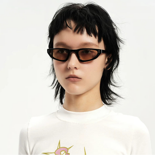 Small Triangular Sunglasses — Model wearing dark triangular sunglasses