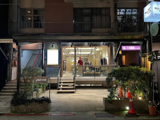 plain-me Taiwan storefront at night — lit select-shop windows