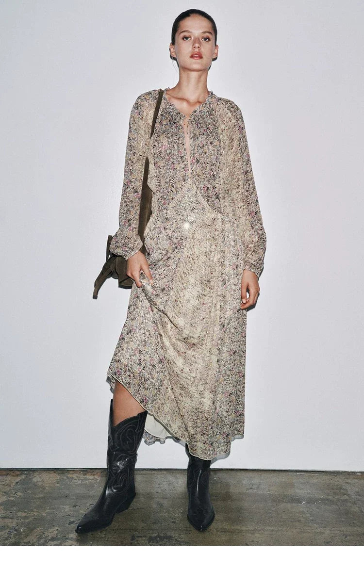 Model wearing black embroidered Western knee-high boots with a dress