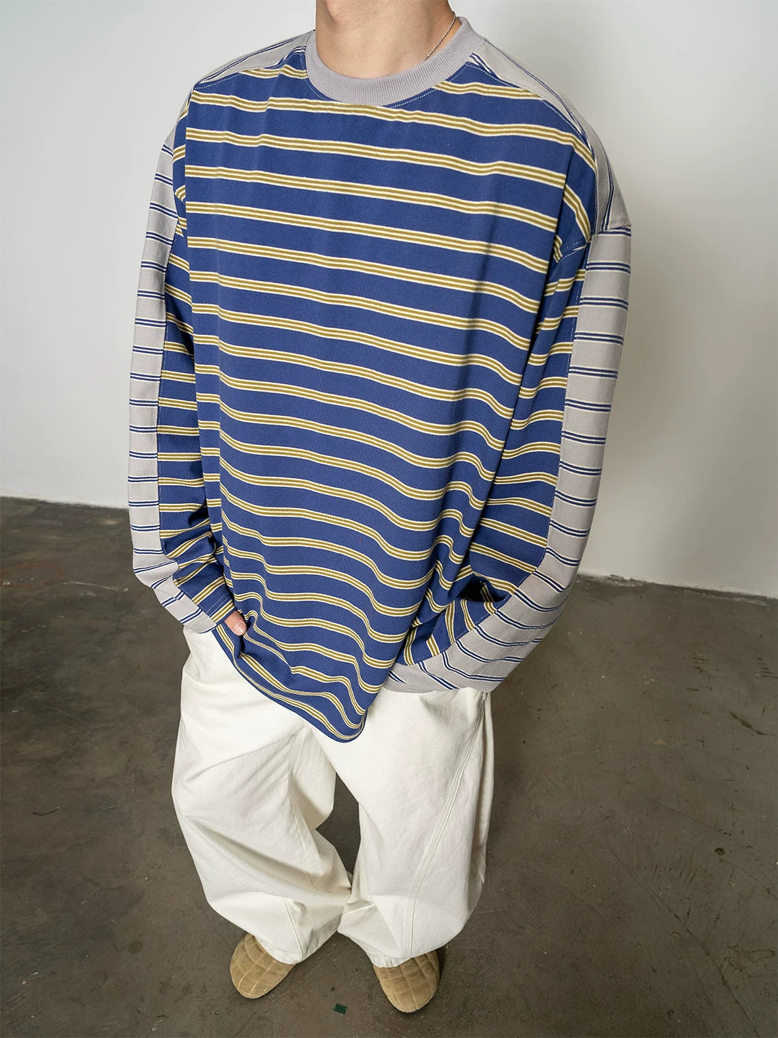 Blue and yellow striped long-sleeve T-shirt, front detail close-up on model