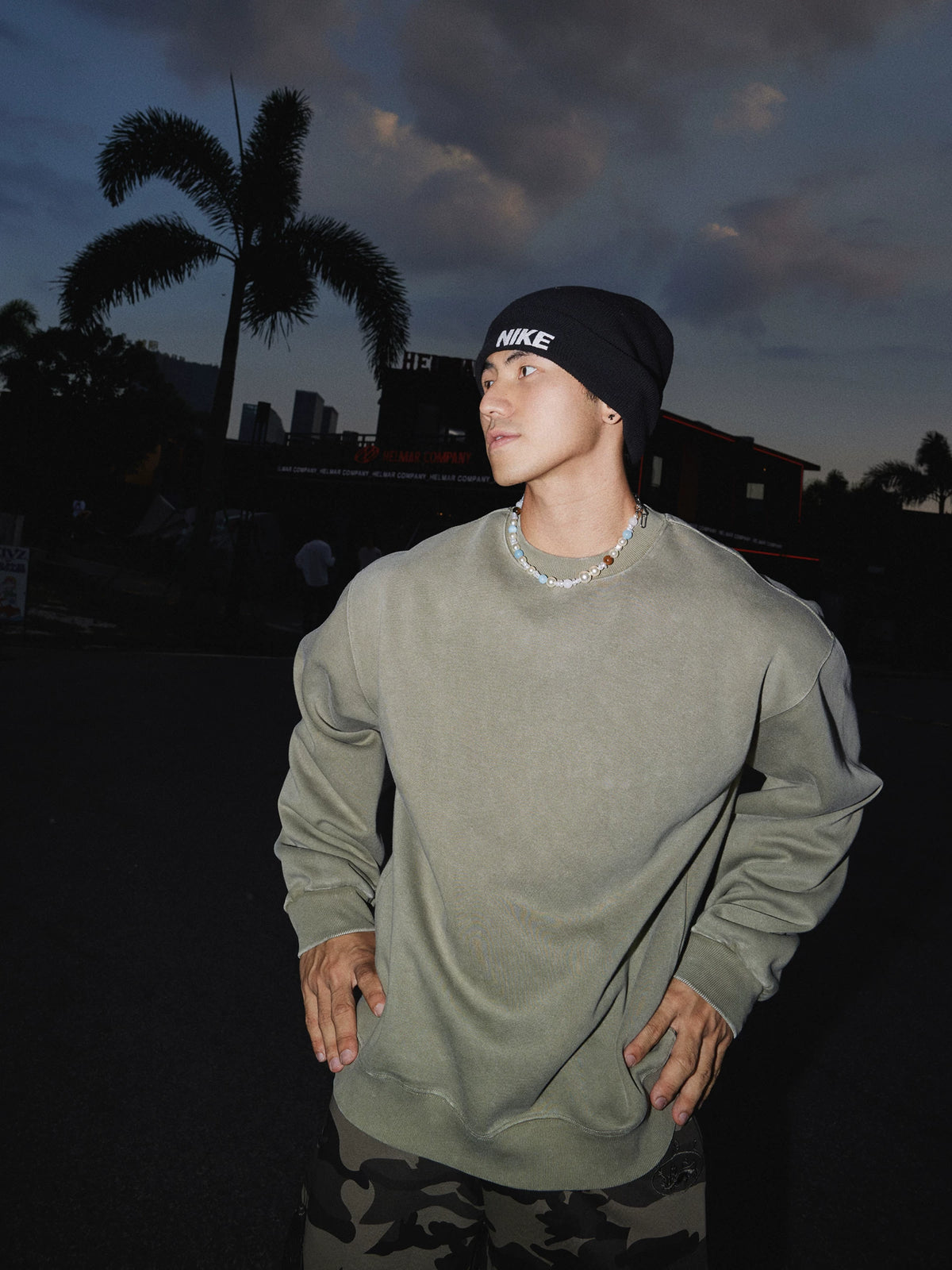Sage green crewneck sweatshirt, side view on model