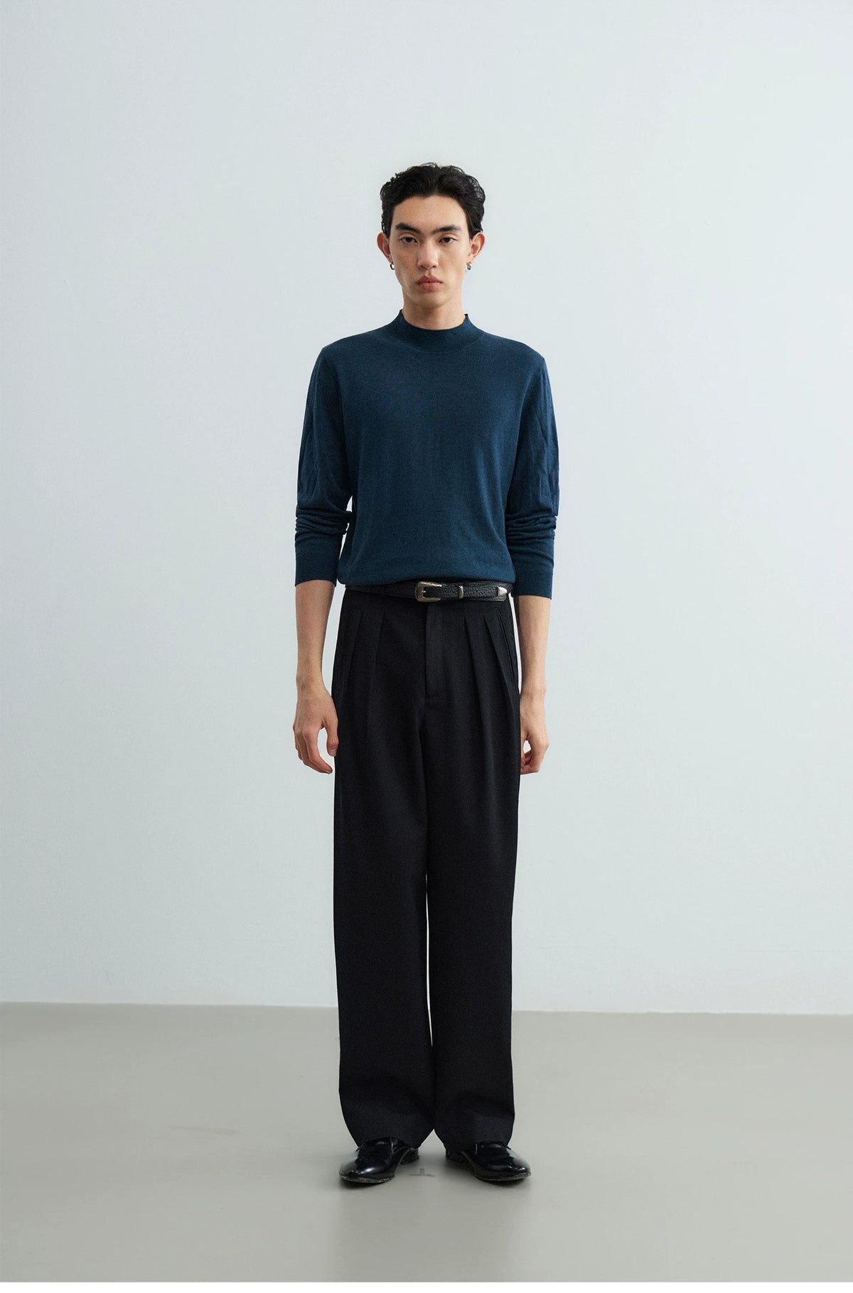 Full outfit with black leather belt, navy knit and black trousers
