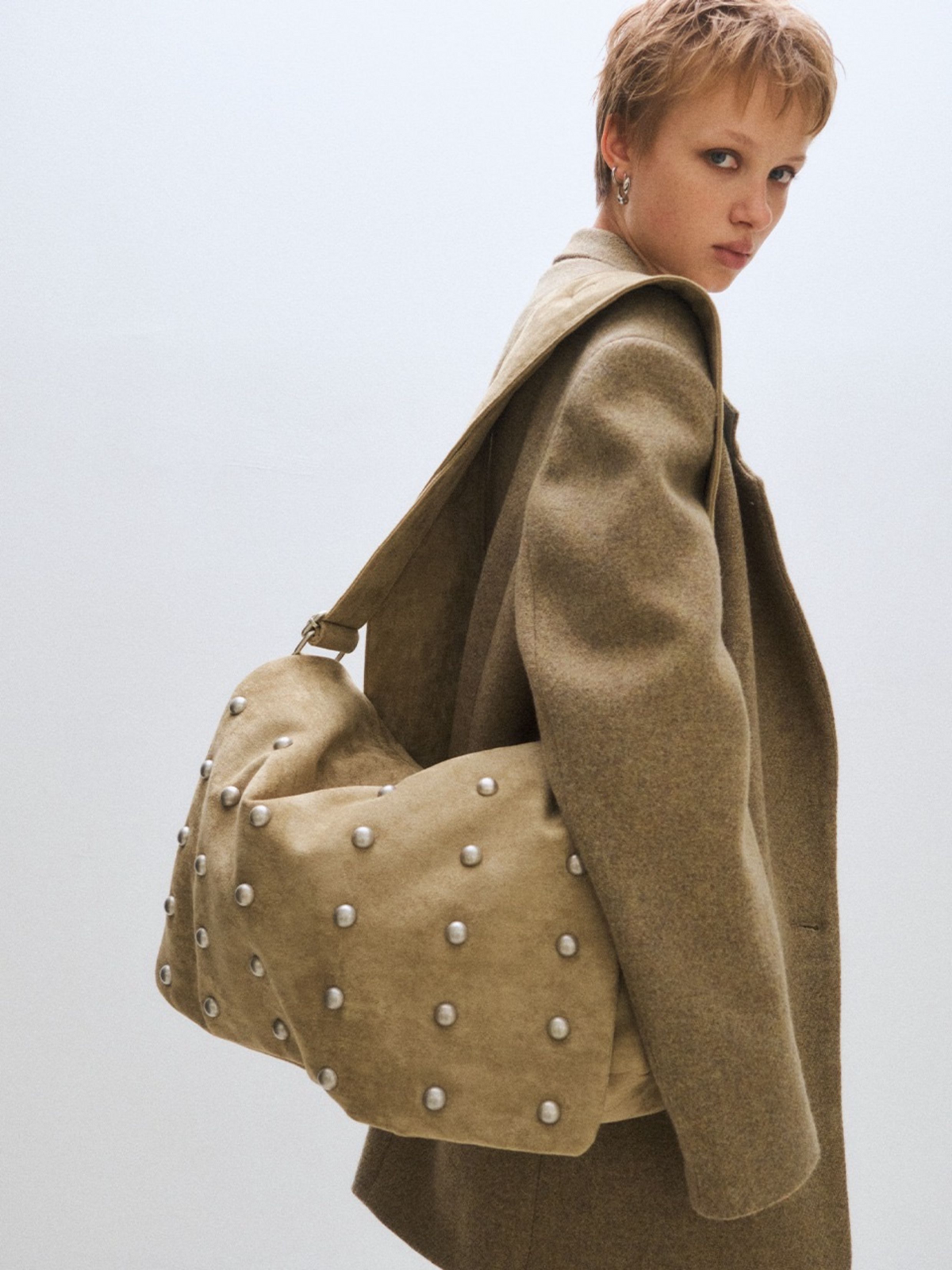 Studded Wide Strap Large Capacity Shoulder Bag in sand worn on the shoulder