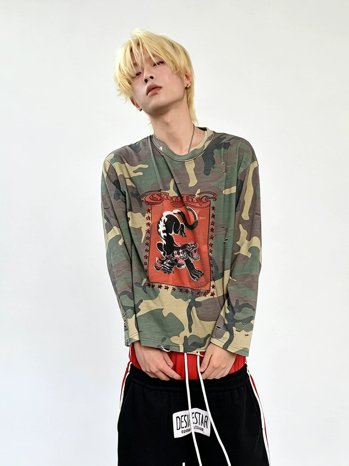 Model wearing the camouflage shirt, front view