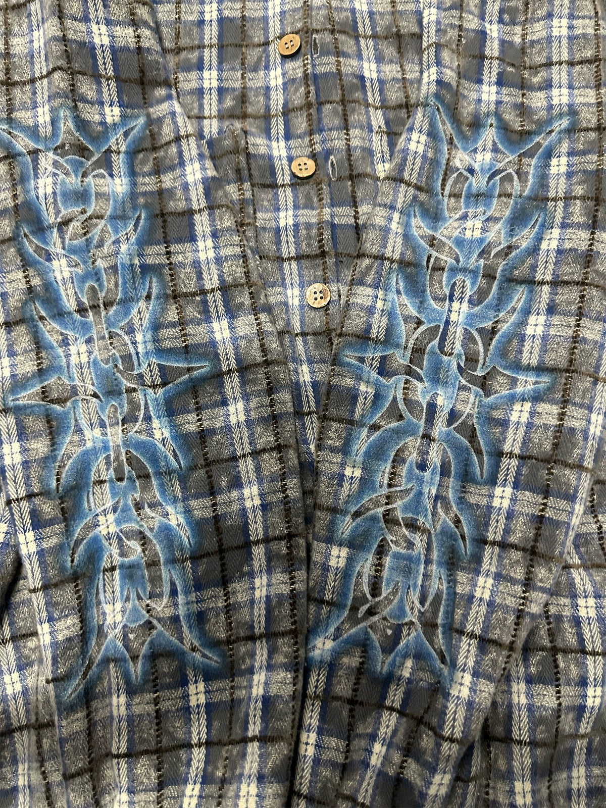 Blue-grey plaid shirt, close view of thorn-print detail