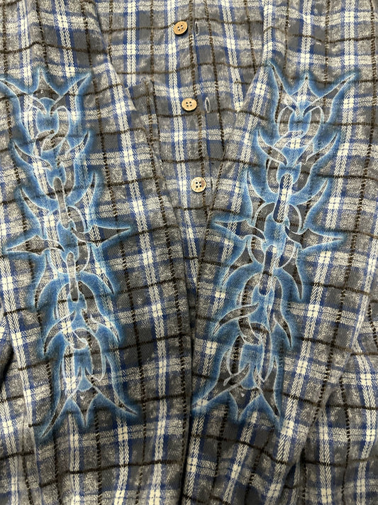 Blue-grey plaid shirt, close view of thorn-print detail