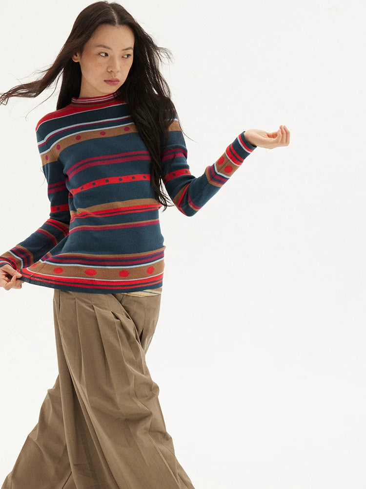Striped knit sweater in navy, red and green, front pose