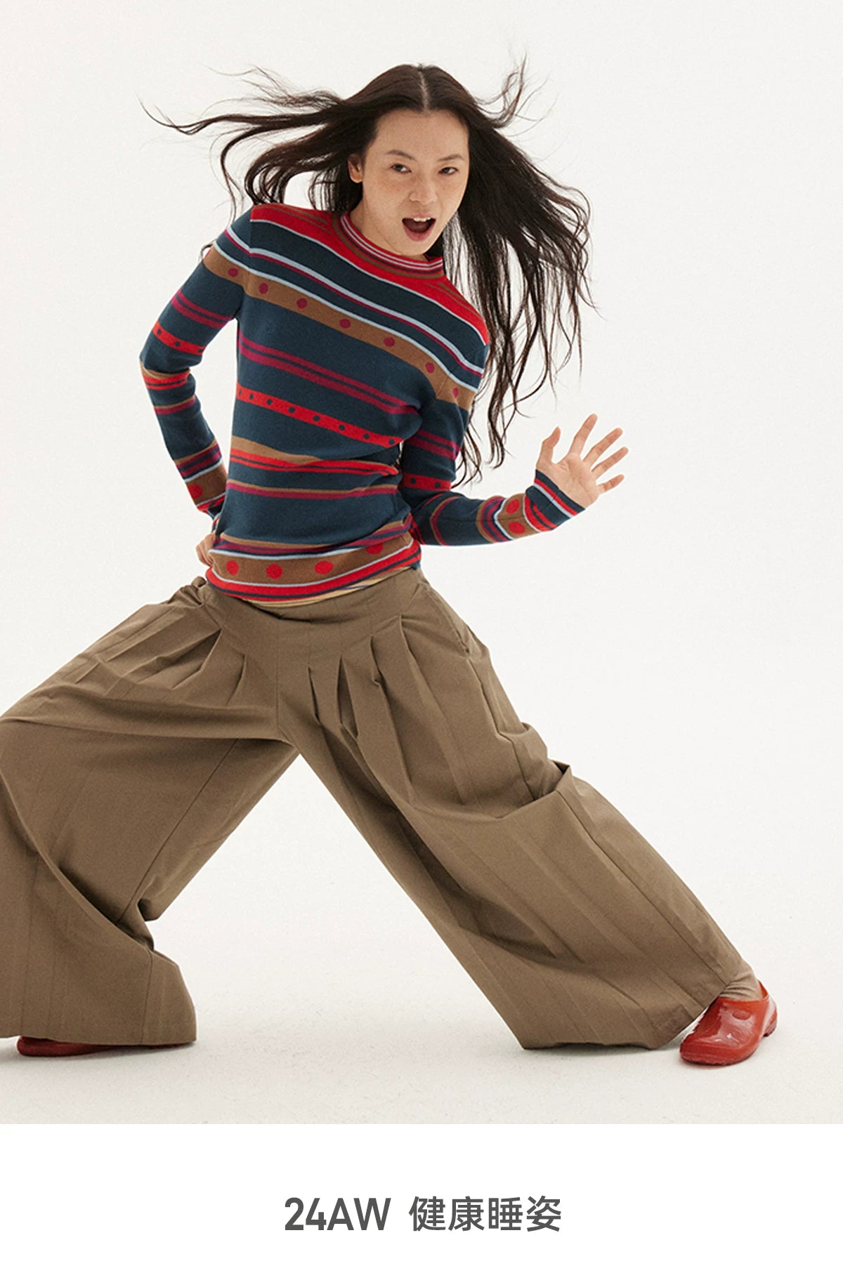 Striped knit sweater in navy, red and green, dynamic pose