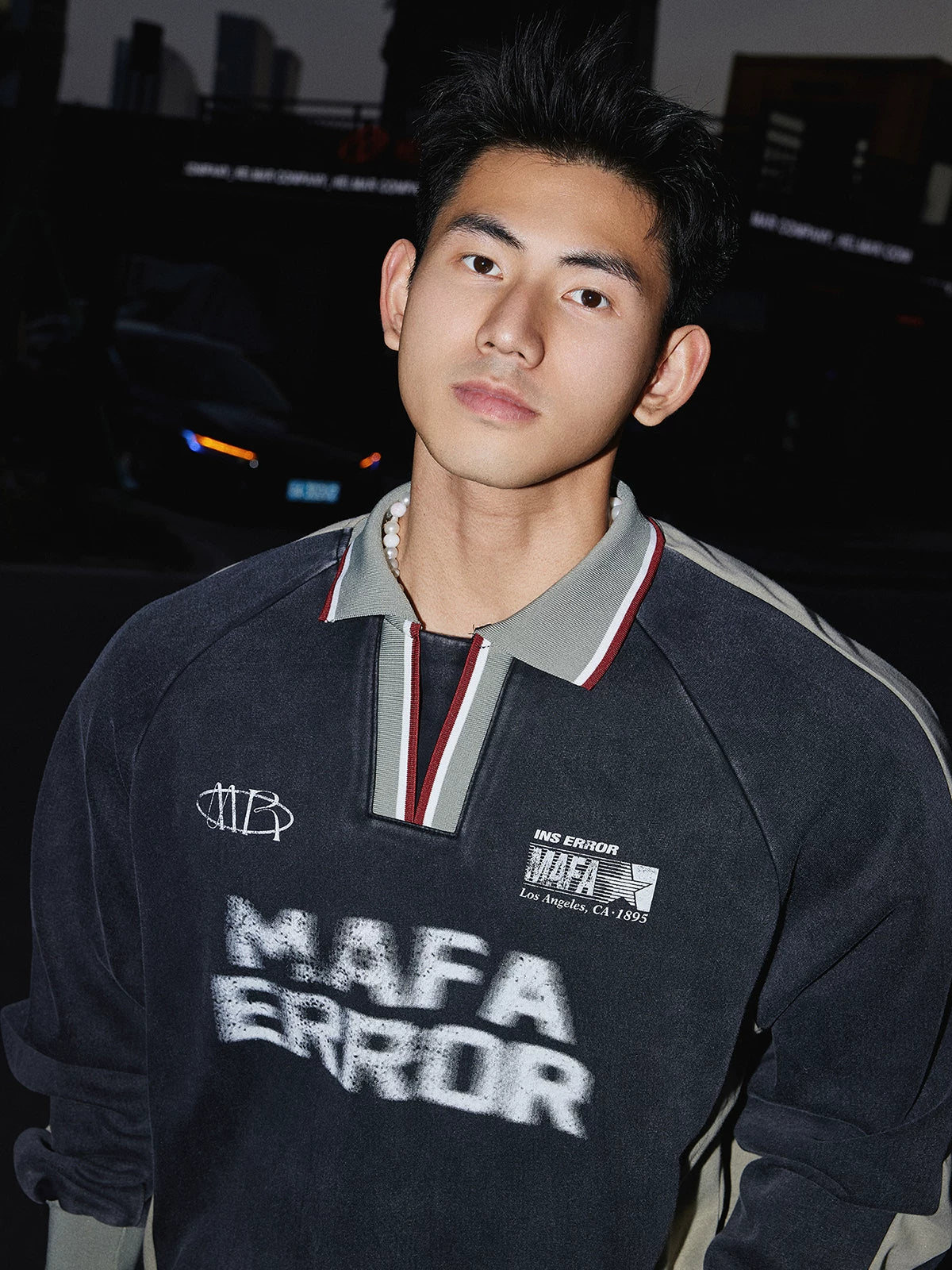 Charcoal pullover sweatshirt, chest print detail close-up on model