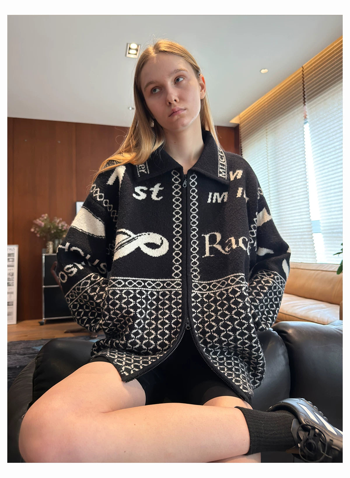 Black patterned cardigan seated view