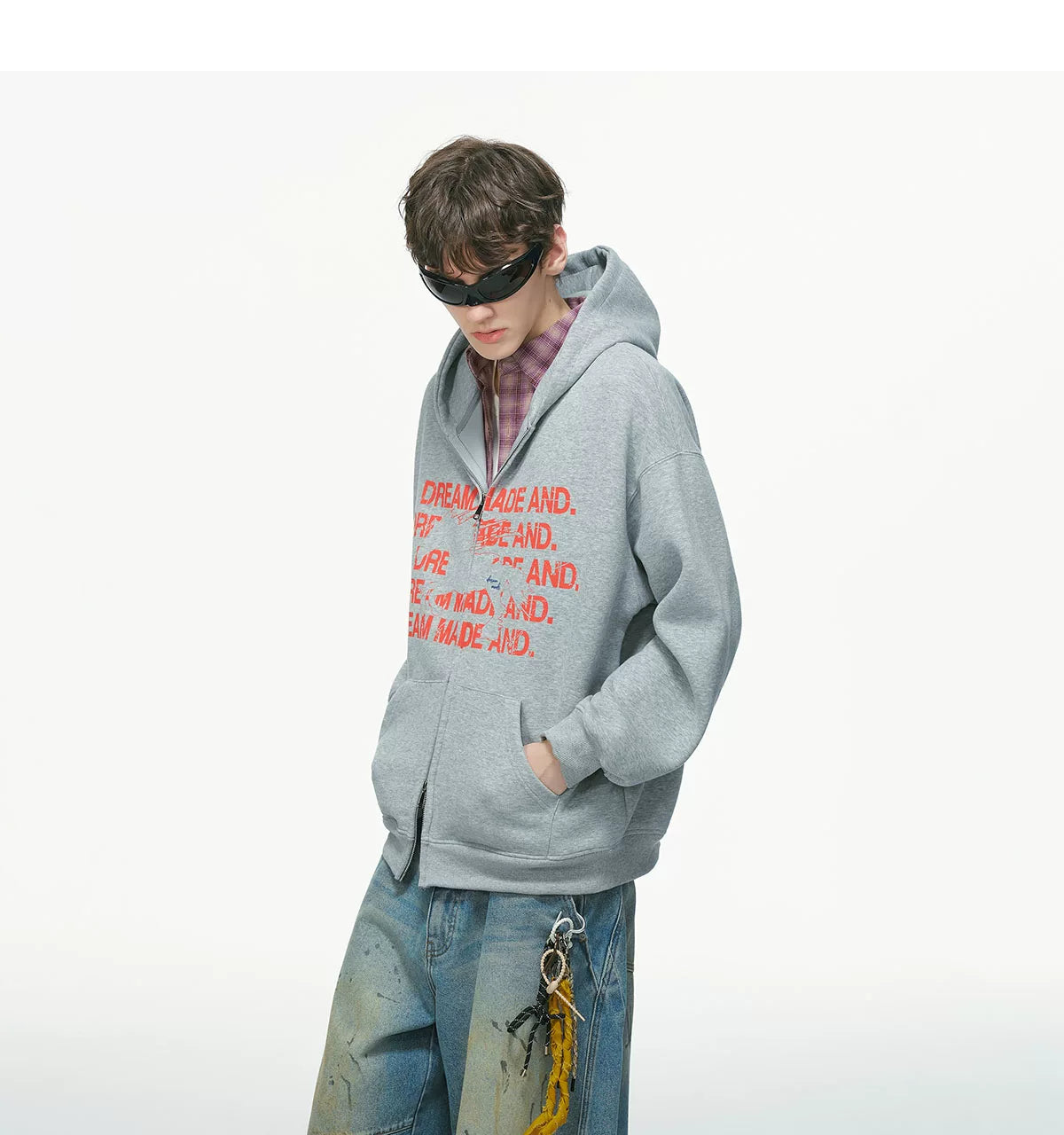 Light gray zip hoodie with red printed text, worn on model, front detail view