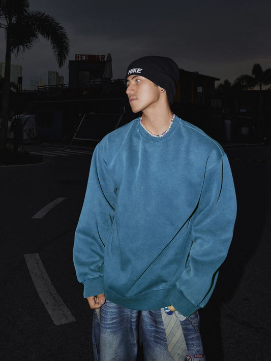 Blue crewneck sweatshirt, side view on model
