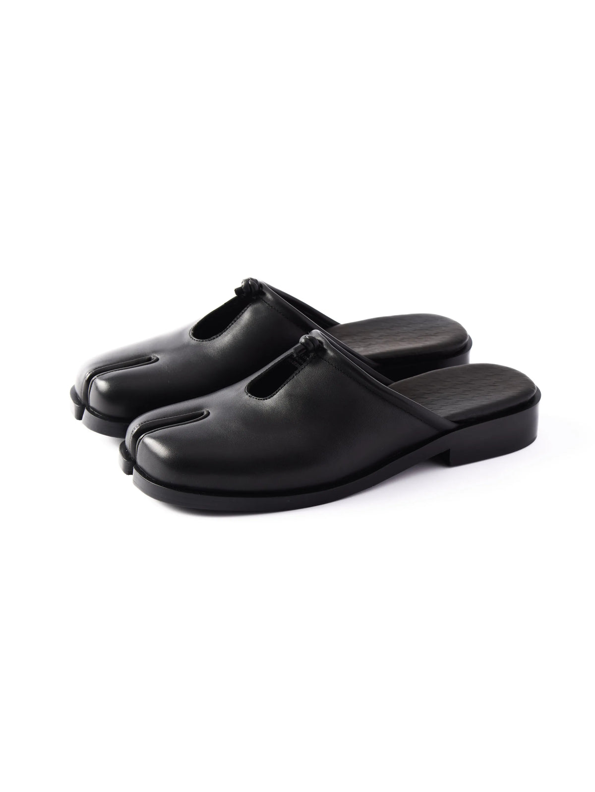Pair of black leather split-toe mules with knotted cutout vamp, angled side view on white background