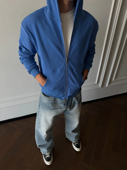 Blue zip-up hoodie, front view on model