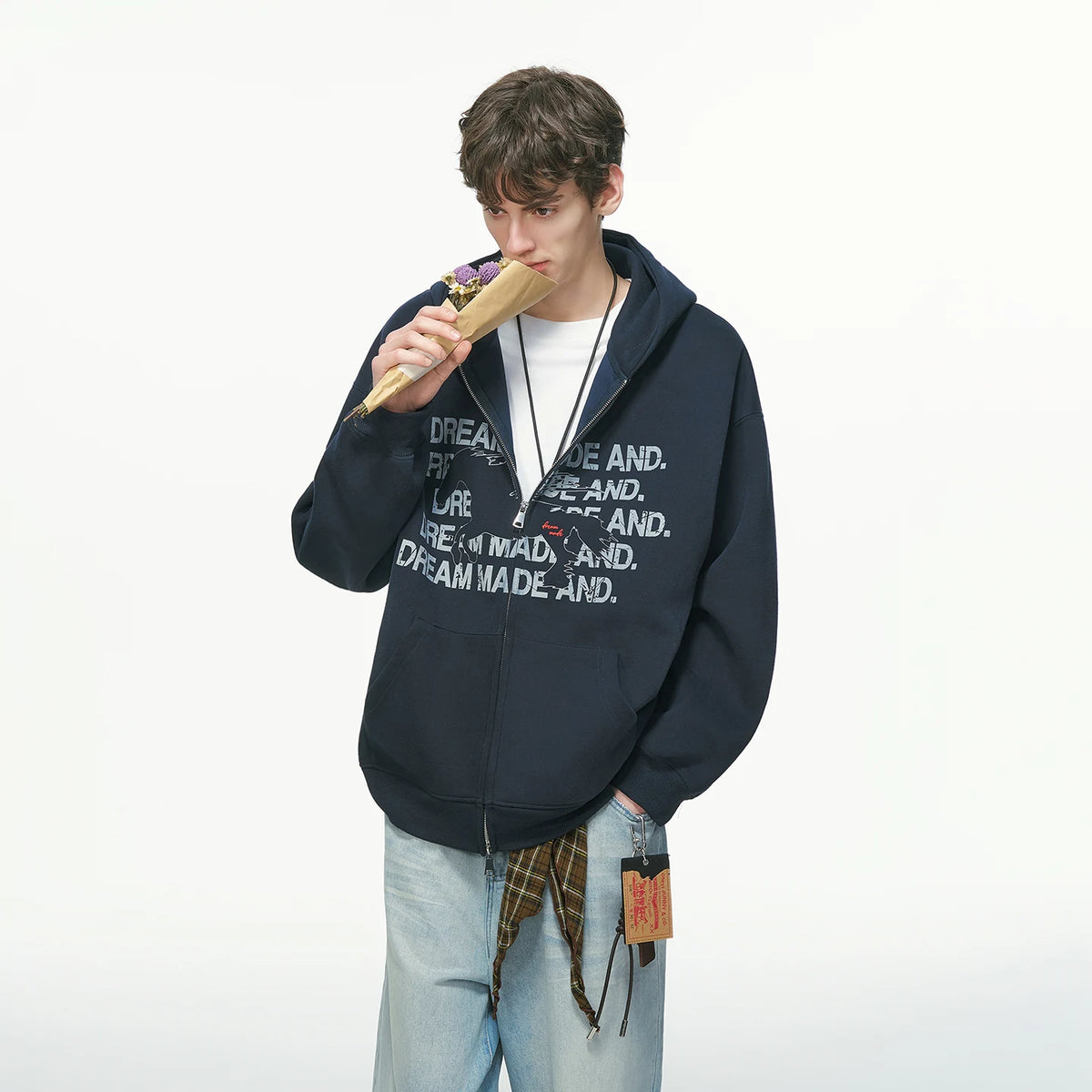 Black pullover hoodie with white printed text, worn on model, front view