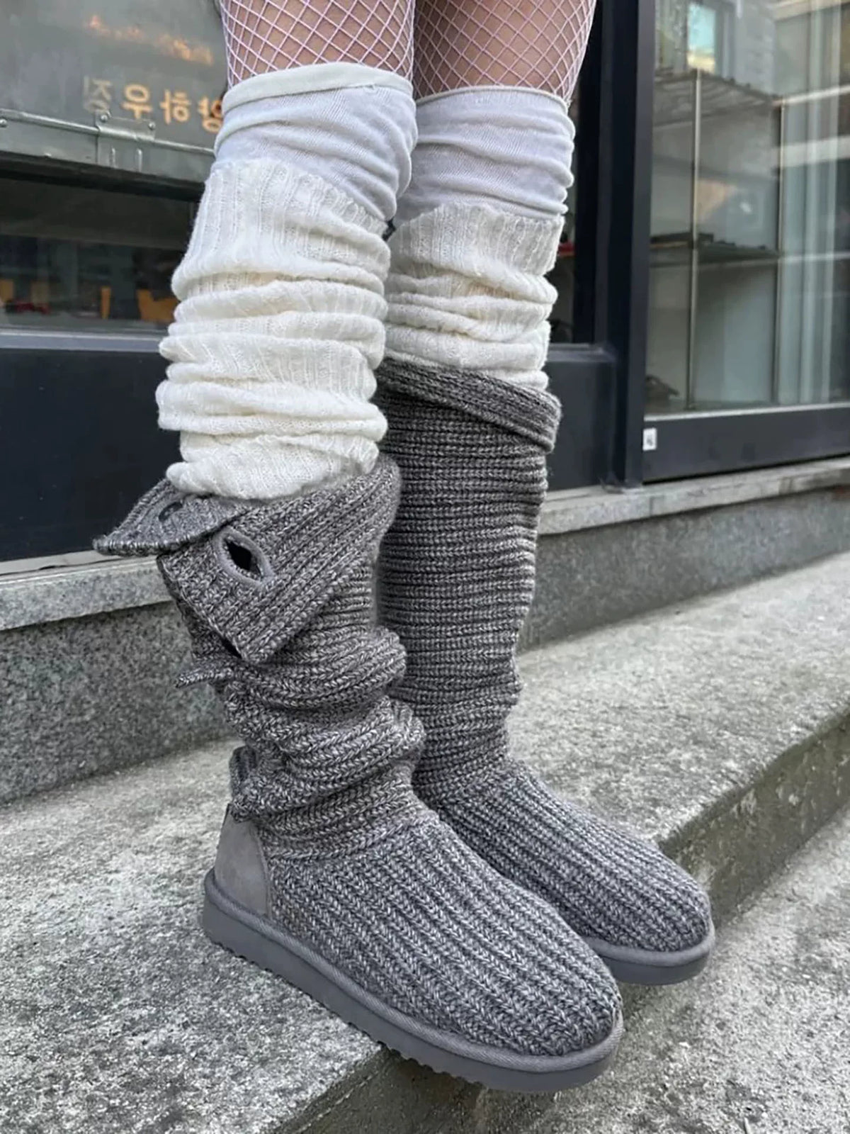 Gray slouch knit boots worn with leg warmers