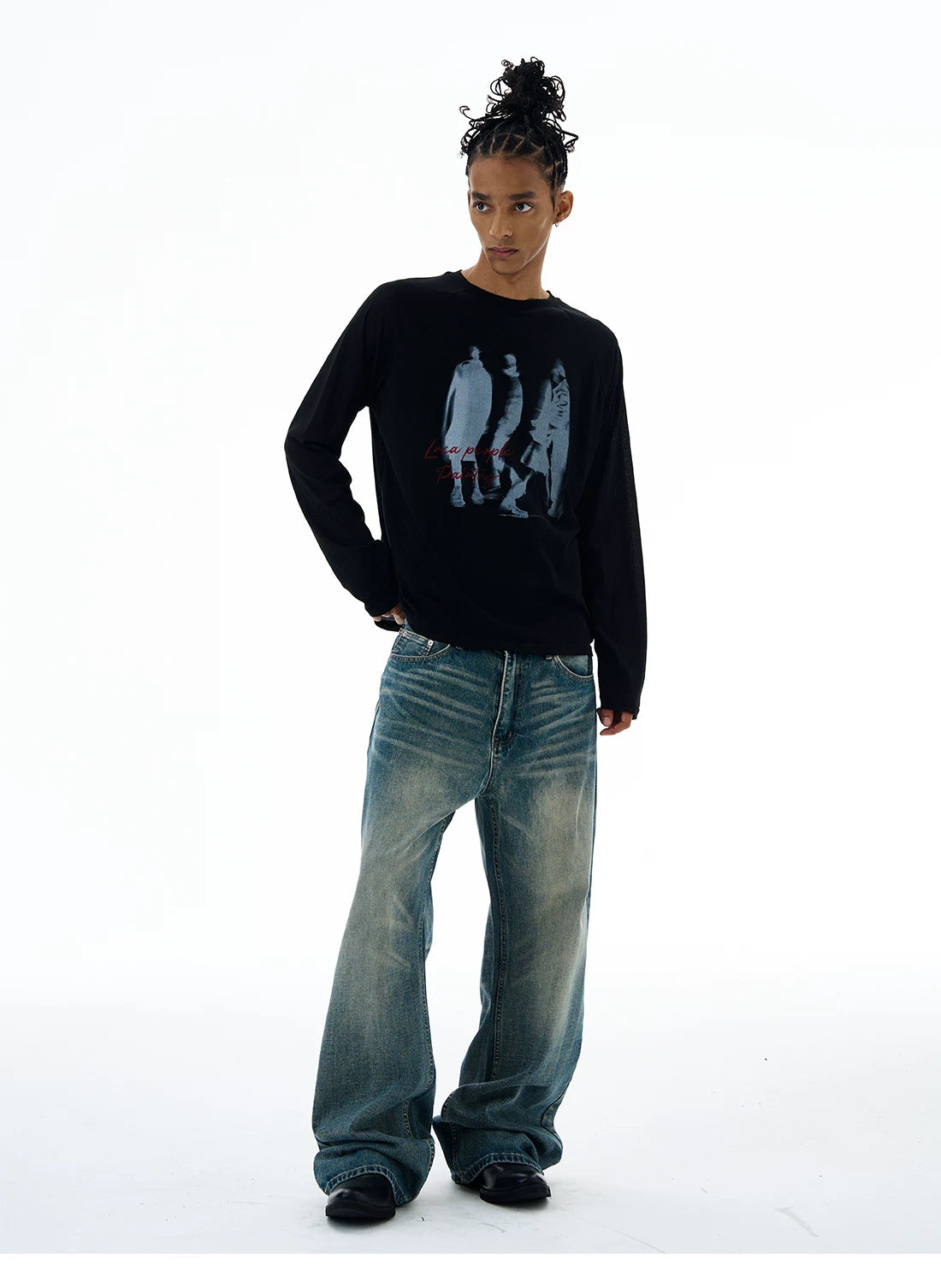 Black graphic T-shirt, relaxed pose