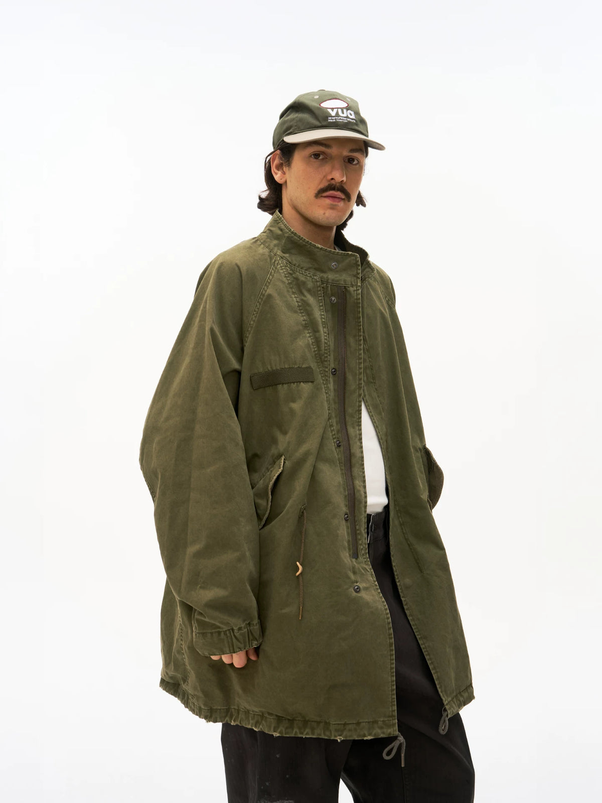 Olive M65 fishtail parka worn on model, side view