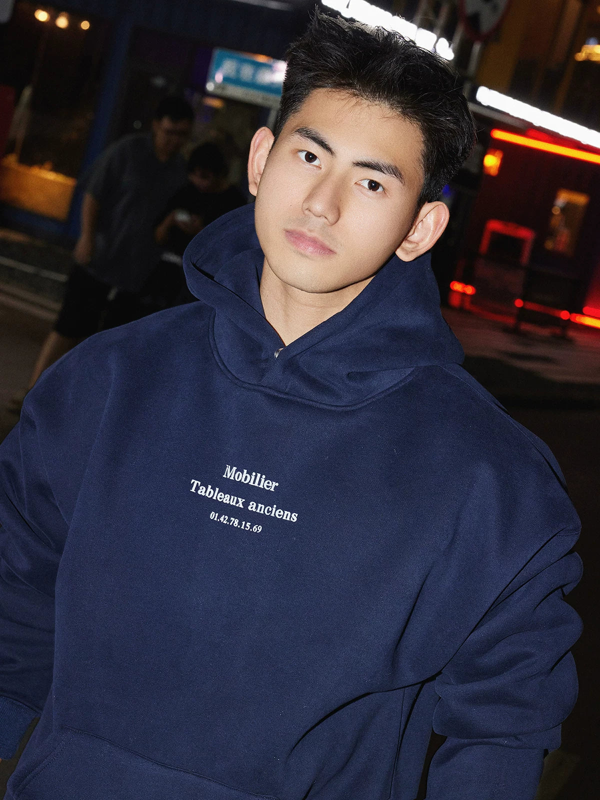 Navy hooded sweatshirt, chest lettering close view
