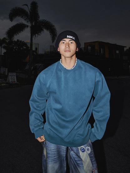 Blue crewneck sweatshirt, front view on model