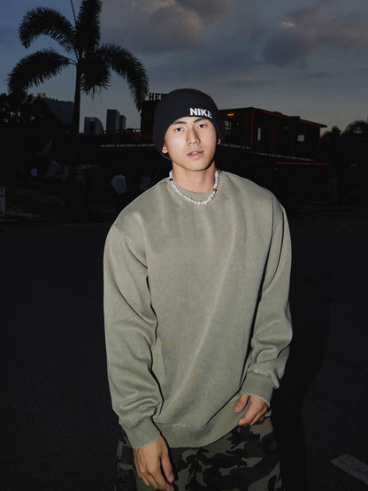 Sage green crewneck sweatshirt, front view on model