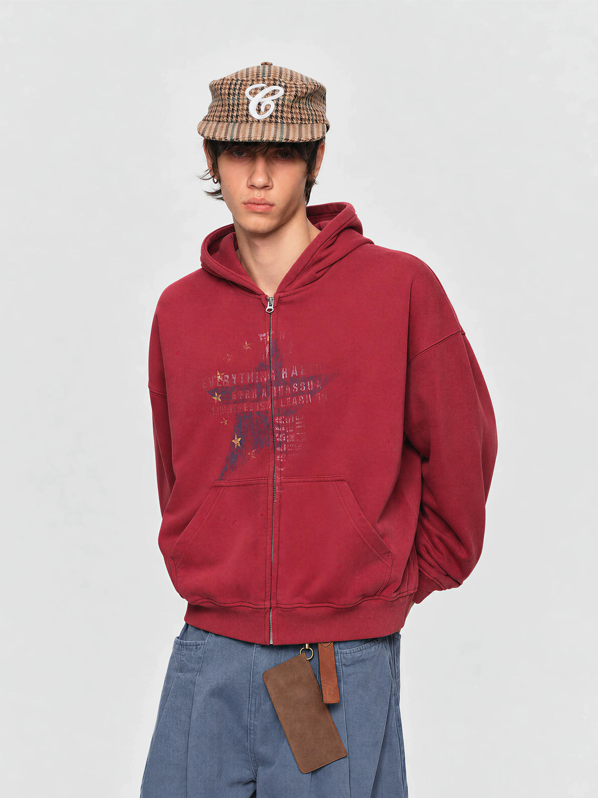 Model wearing the red star-print hoodie