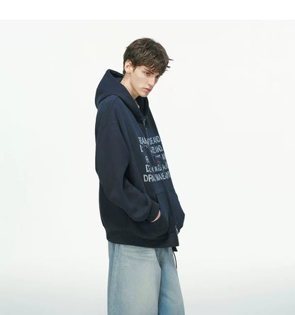 Black pullover hoodie with white printed text, worn on model, side view