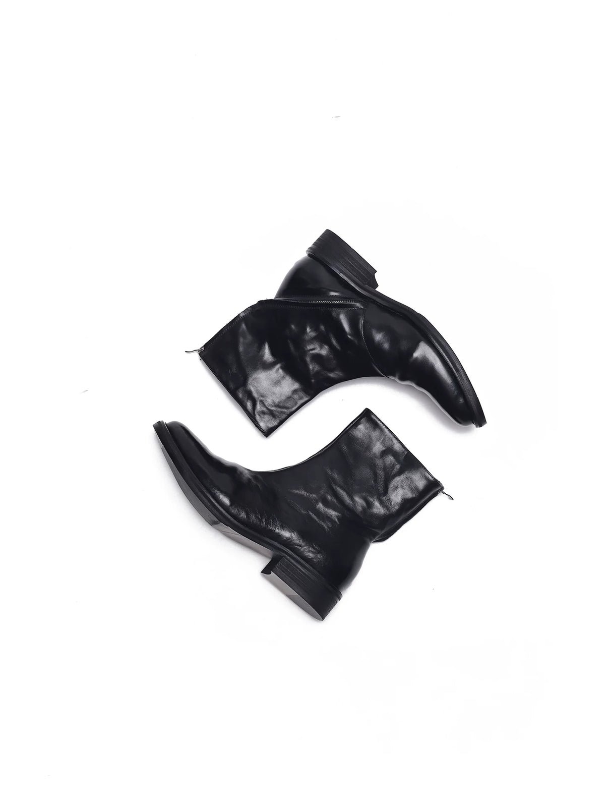 Black wrinkled leather ankle boots on a white background