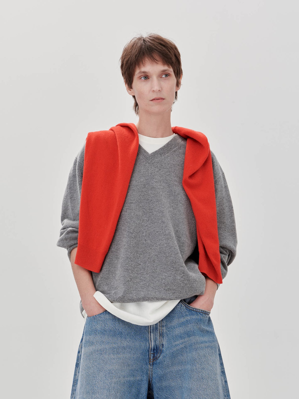 Wool cashmere crewneck sweater, model wearing red and gray V-neck sweater