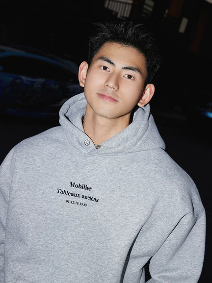 Grey hooded sweatshirt, chest lettering close view
