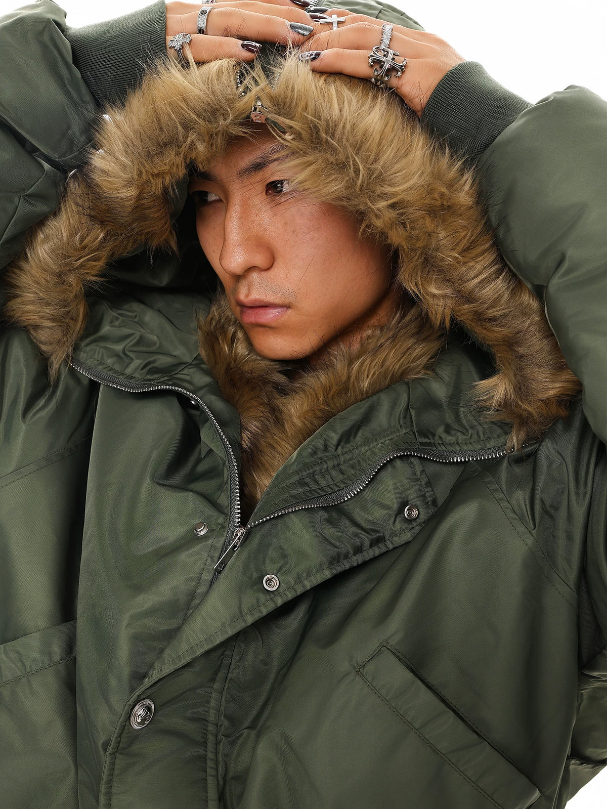 Olive green bomber jacket with brown faux fur hood, detail close-up on model