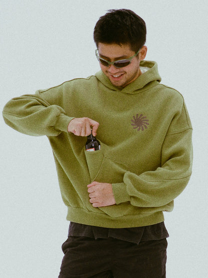 Front view of the olive hoodie worn with sunglasses