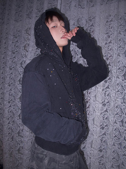 Black rhinestone hoodie worn by a model