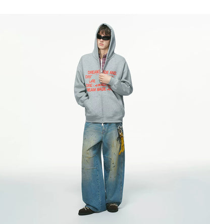 Black pullover hoodie with white printed text, worn on model, front view