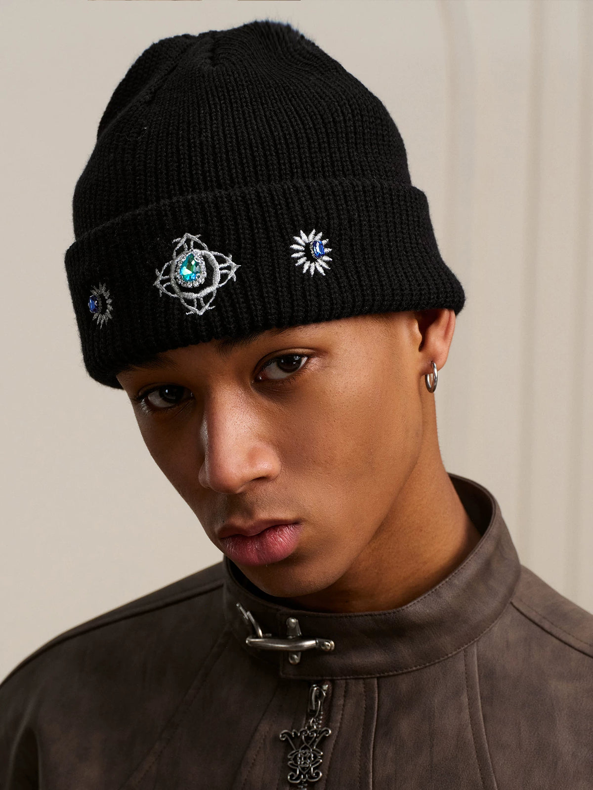 Black embroidered knit beanie on a model