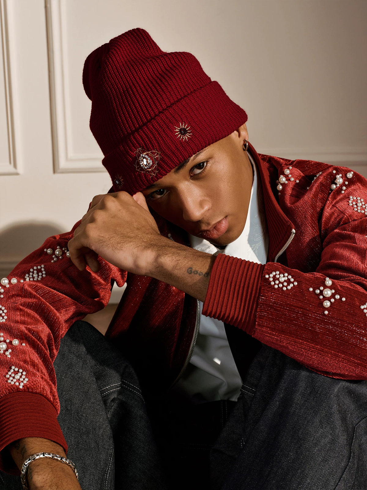 Red embroidered knit beanie on a model