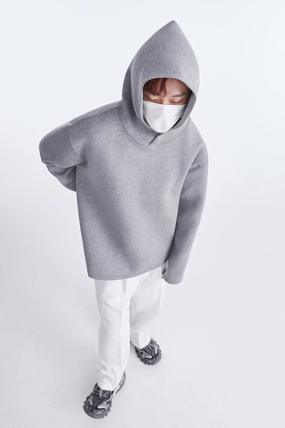 Grey hoodie, full-length front view with white trousers
