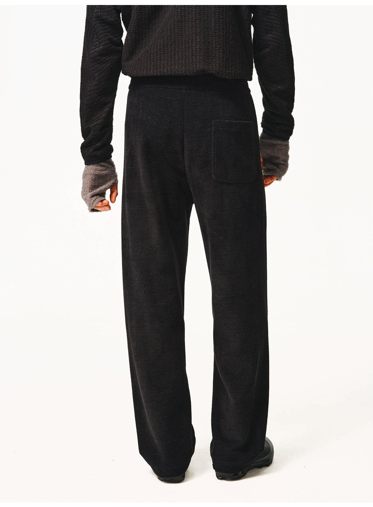 Black waffle-knit pants, back view