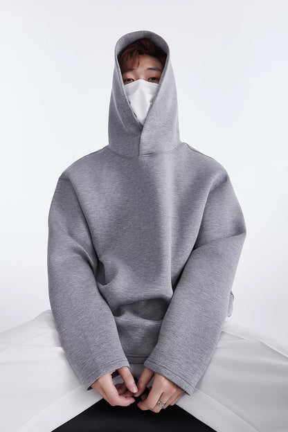 Grey hoodie, seated front view showing hood and button neckline