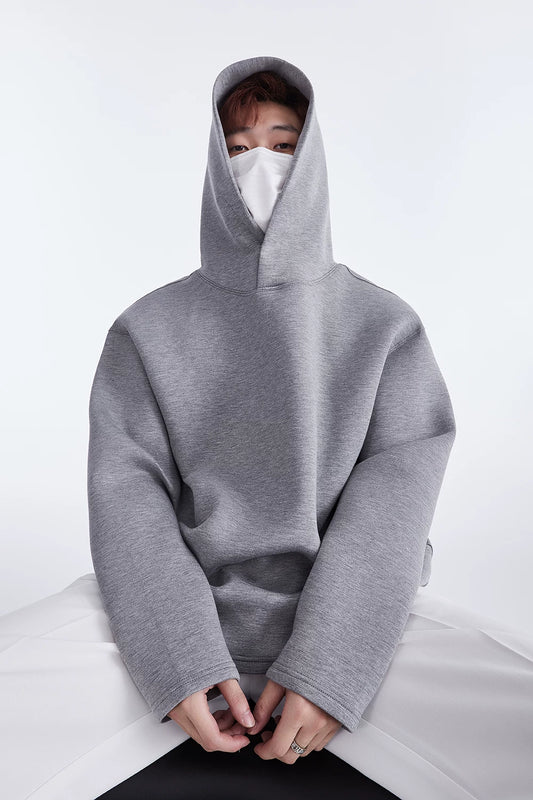 Grey hoodie, seated front view showing hood and button neckline
