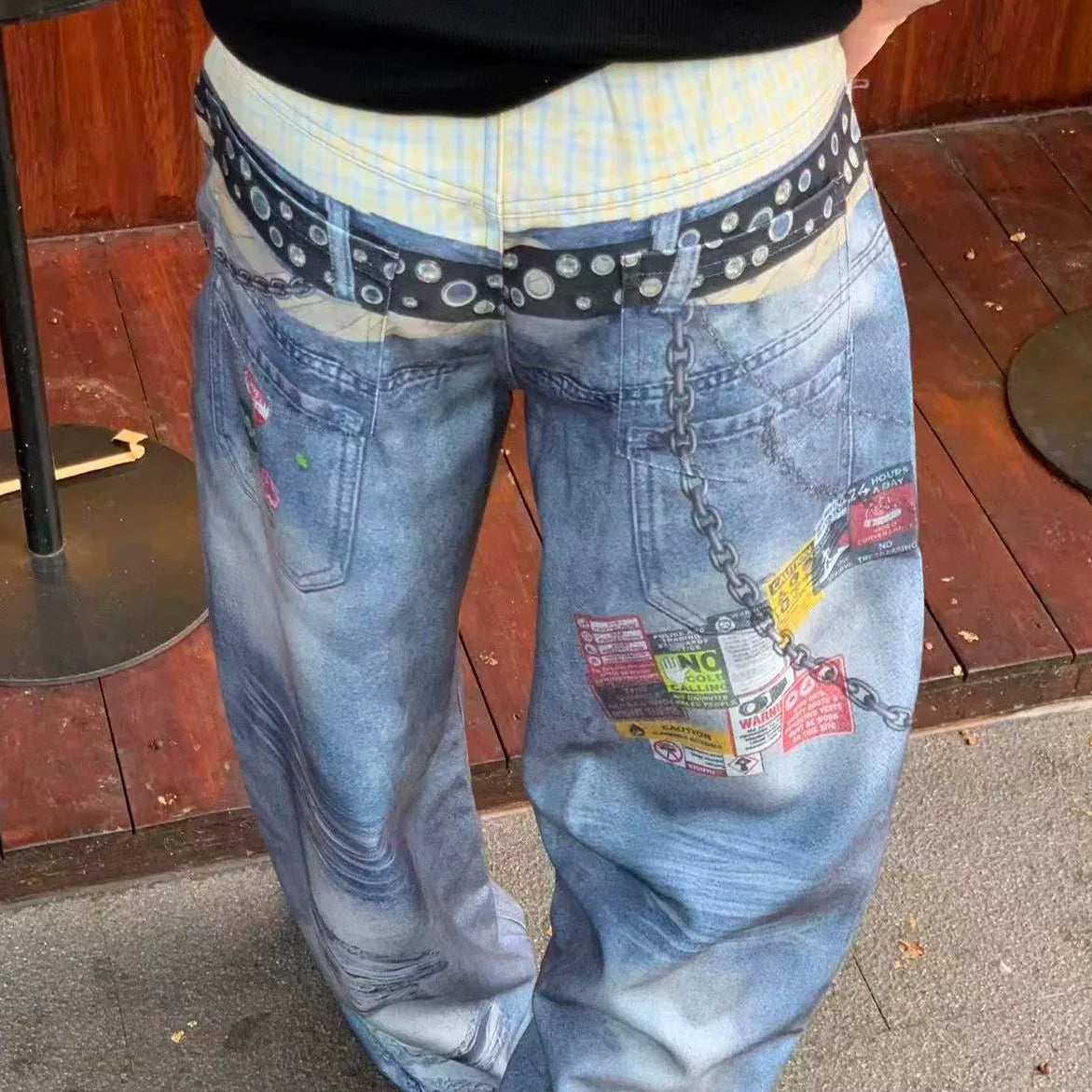 Light blue jeans, close front view of patterned waistband and patches