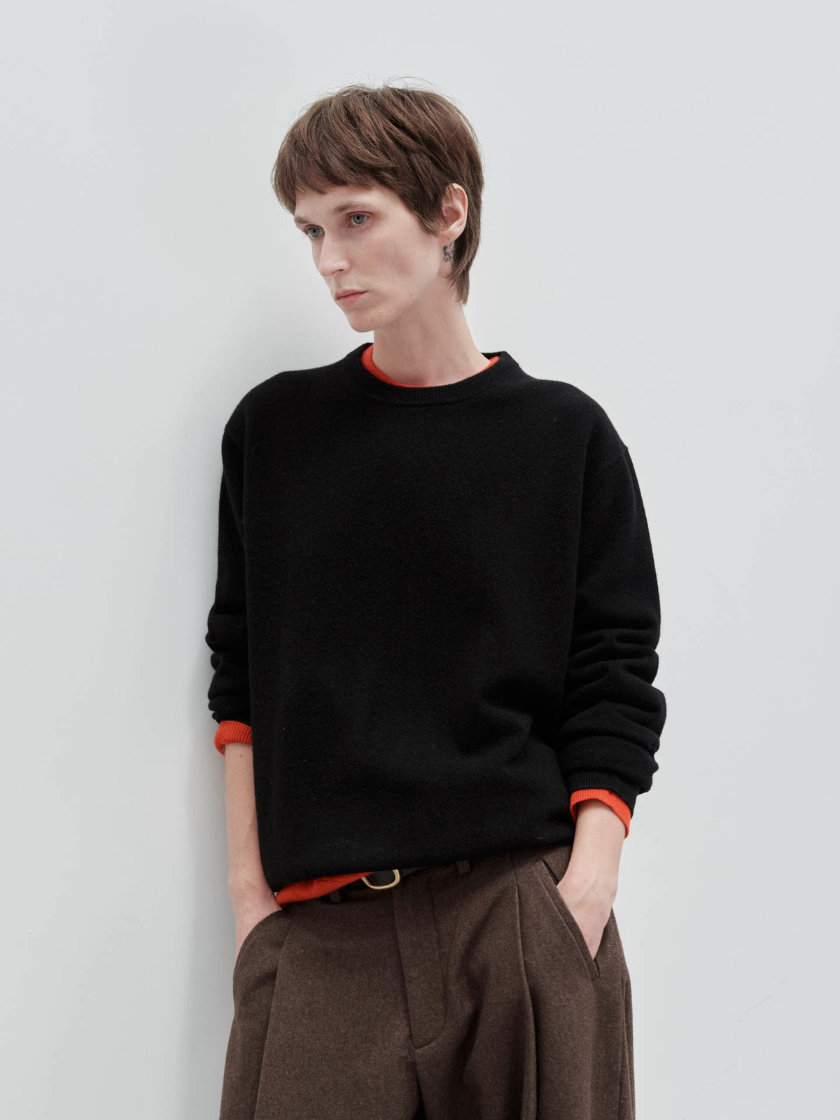 Wool cashmere crewneck sweater, model wearing black crewneck sweater