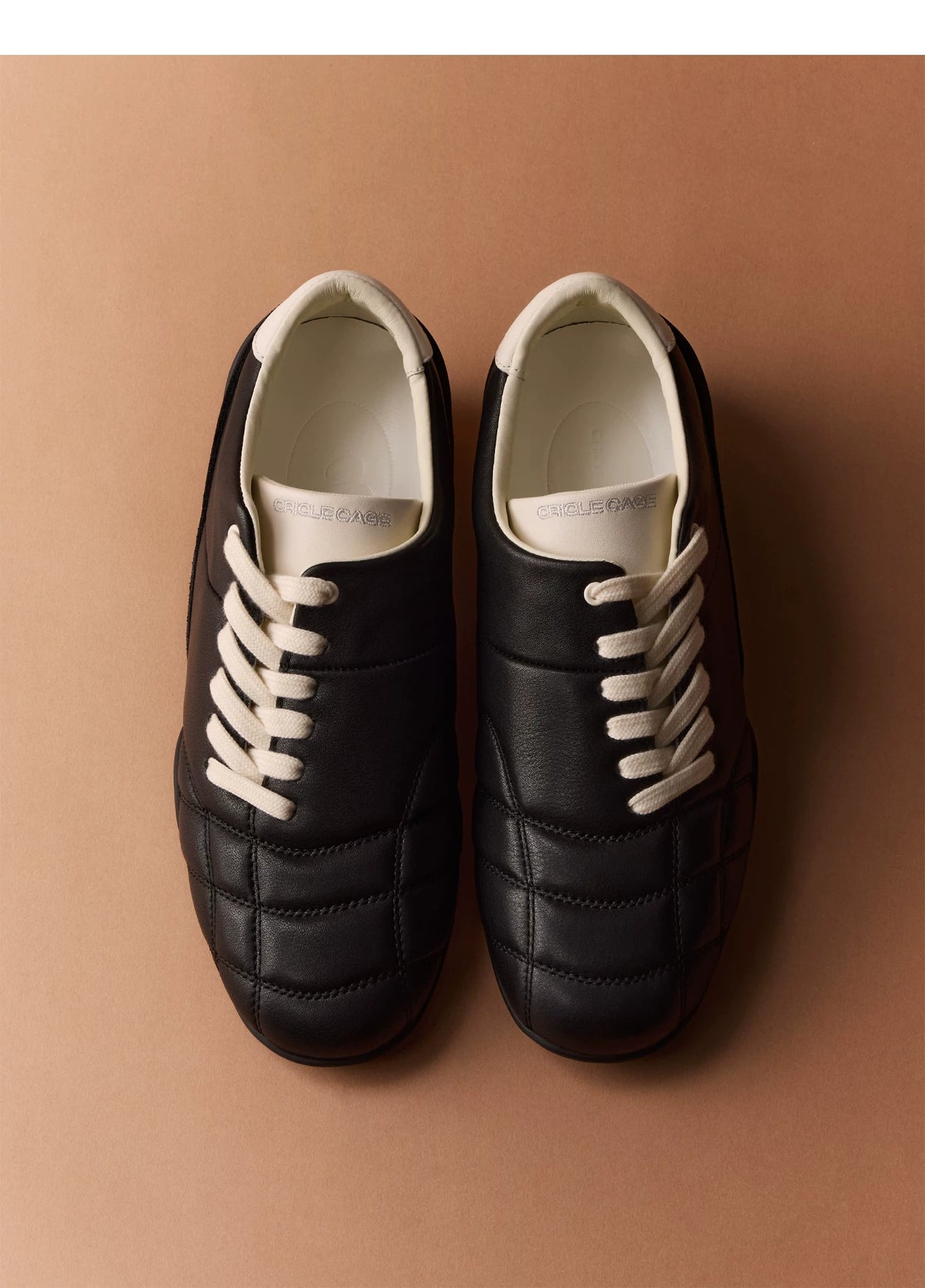 Black Low-Profile Trainer Sneakers — black and cream pair, top view