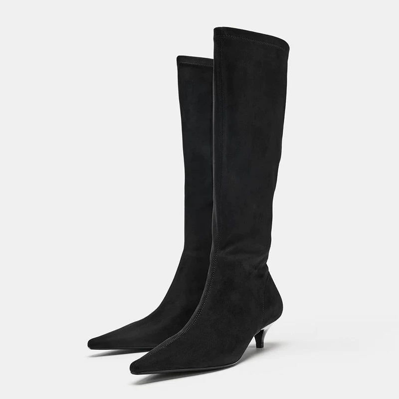 Black pointed-toe kitten-heel knee-high boots, angled pair