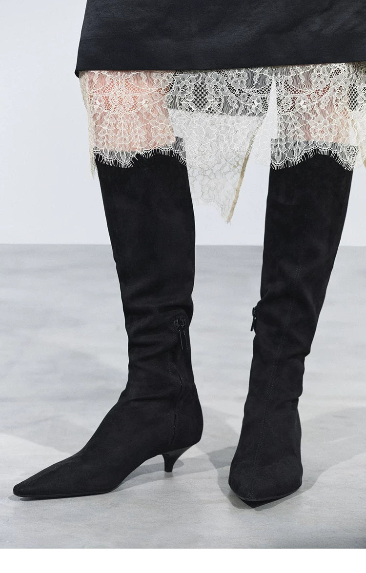 Black pointed-toe knee-high boots, front outfit detail with lace hem