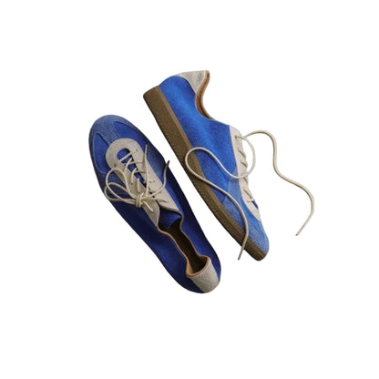 Blue Vintage German Sneakers suspended against a gray background, top and side views