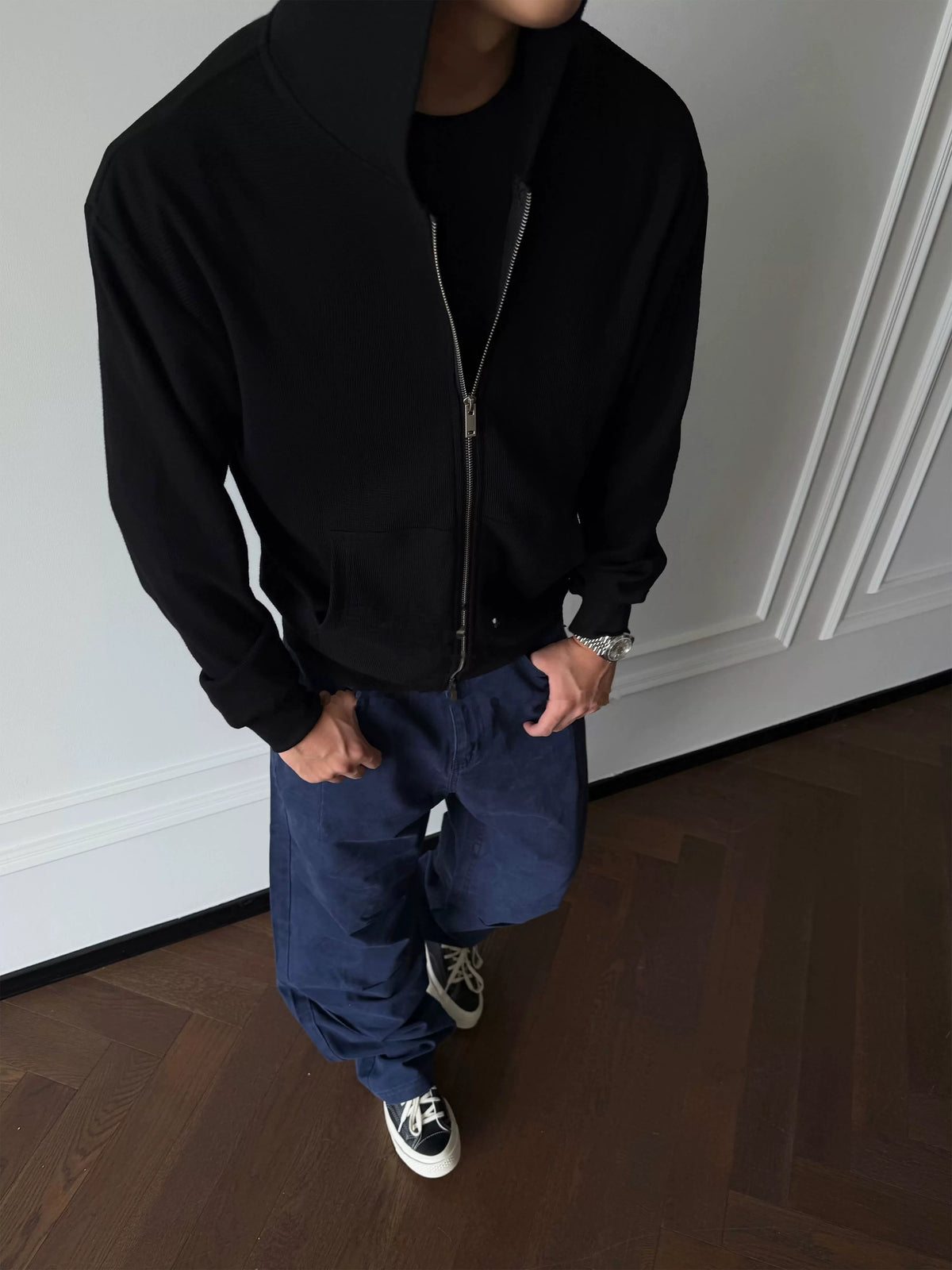 Black zip-up hoodie, front view on model